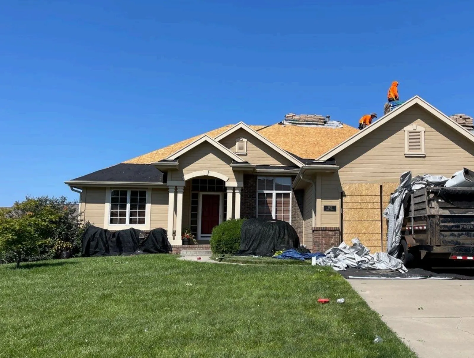 A Rocket Roofing General Contractor crew replacing a roof in Omaha.